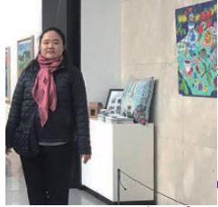 THISABLED’s Artist Standing in front of her Artwork at an Exhibition (instagram.com/thisabled_inc)